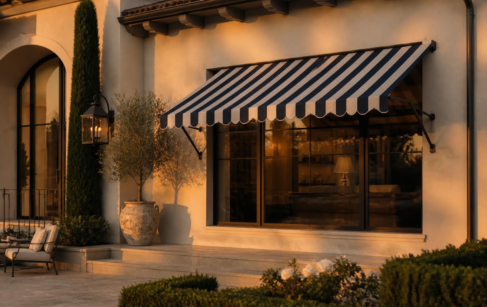 Navy and cream striped custom awning over a large window on an upscale home